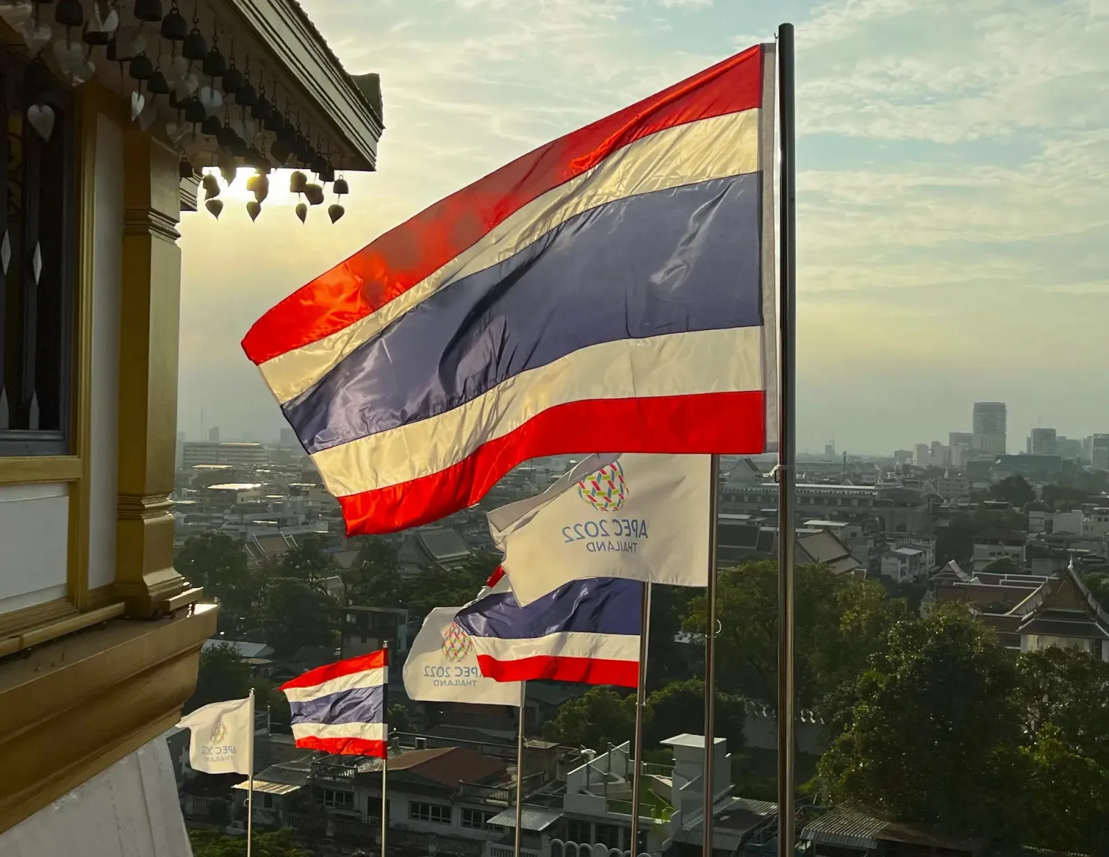 Flying Thai Flag by Mr. Wanderer Alternating Thai and APEC 2022 flags flying in reverse with the wind overlooking the city