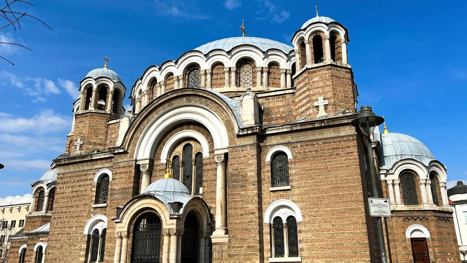 Sofia Domed Church by Mr. Wanderer Brick structure with white-arches and metal domes.
