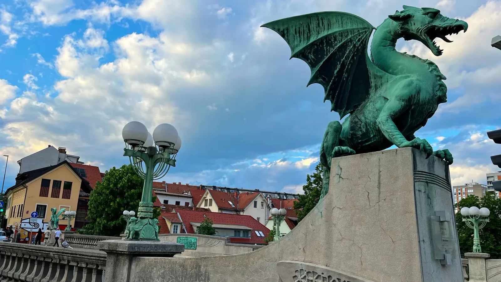 Dragon Bridge by Mr. Wanderer Patinaed dragon sculpture nested atop a stone bridge