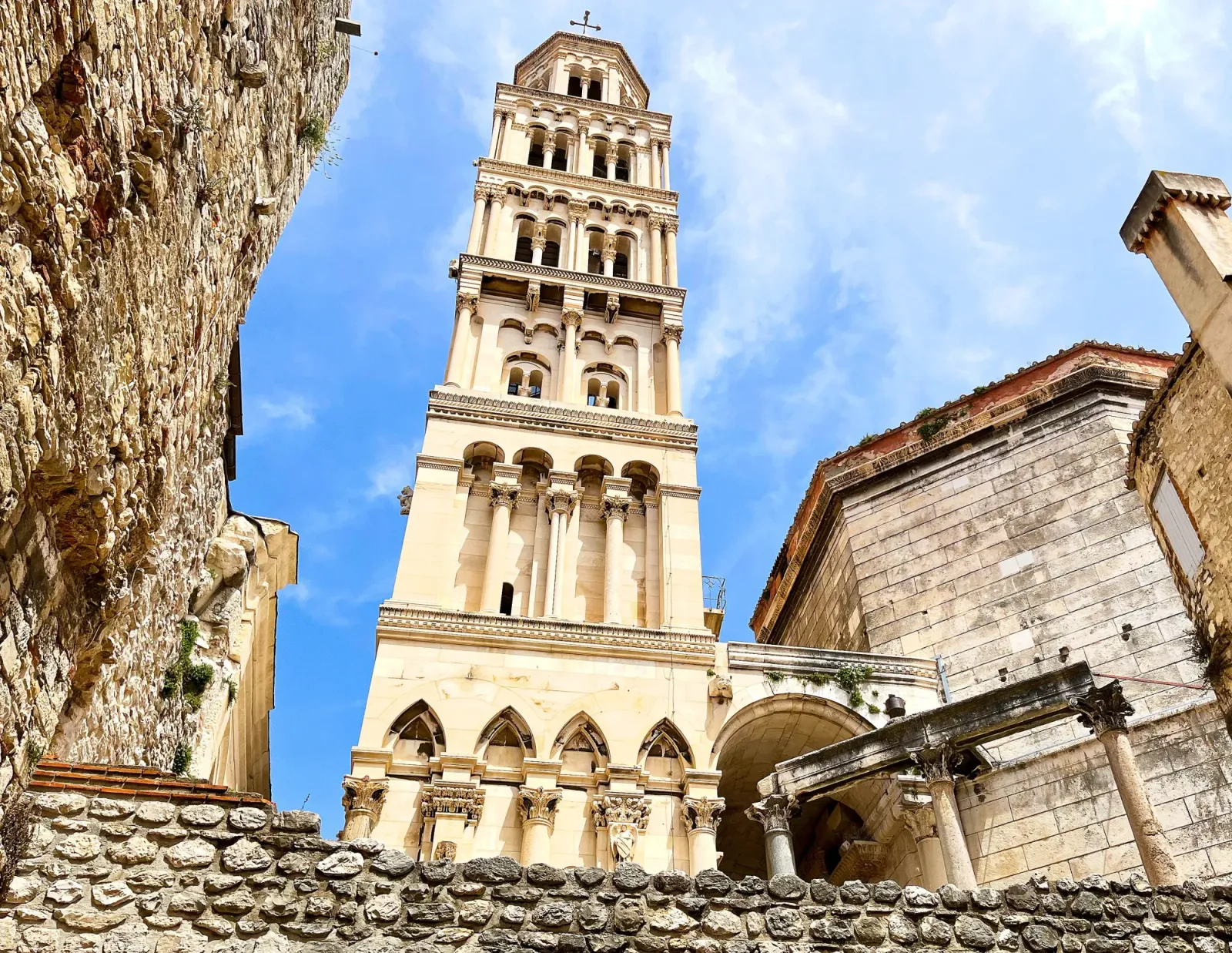 Diocletian's Palace Asset by Mr. Wanderer Tan stone tower set amidst darker stone buildings