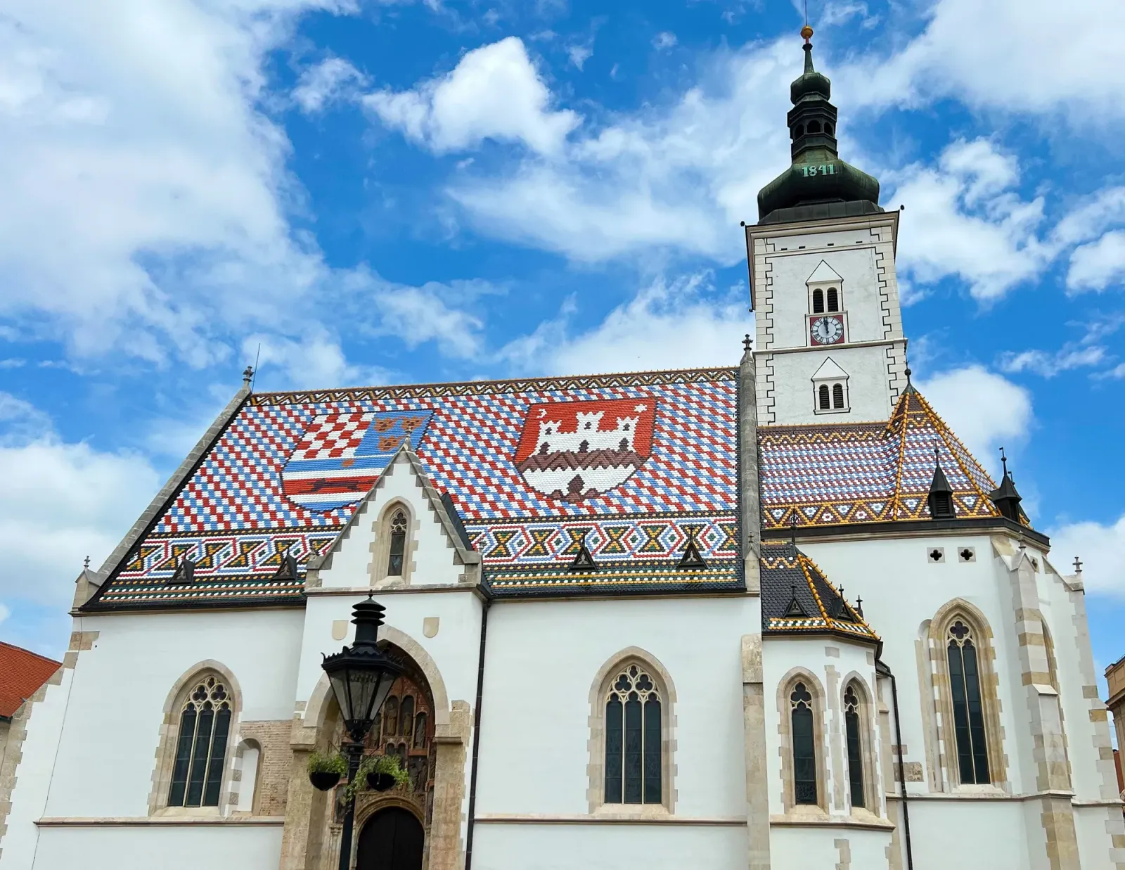 St. Mark's Church by Mr. Wanderer Blue, White, and Red tiled roof on a white church