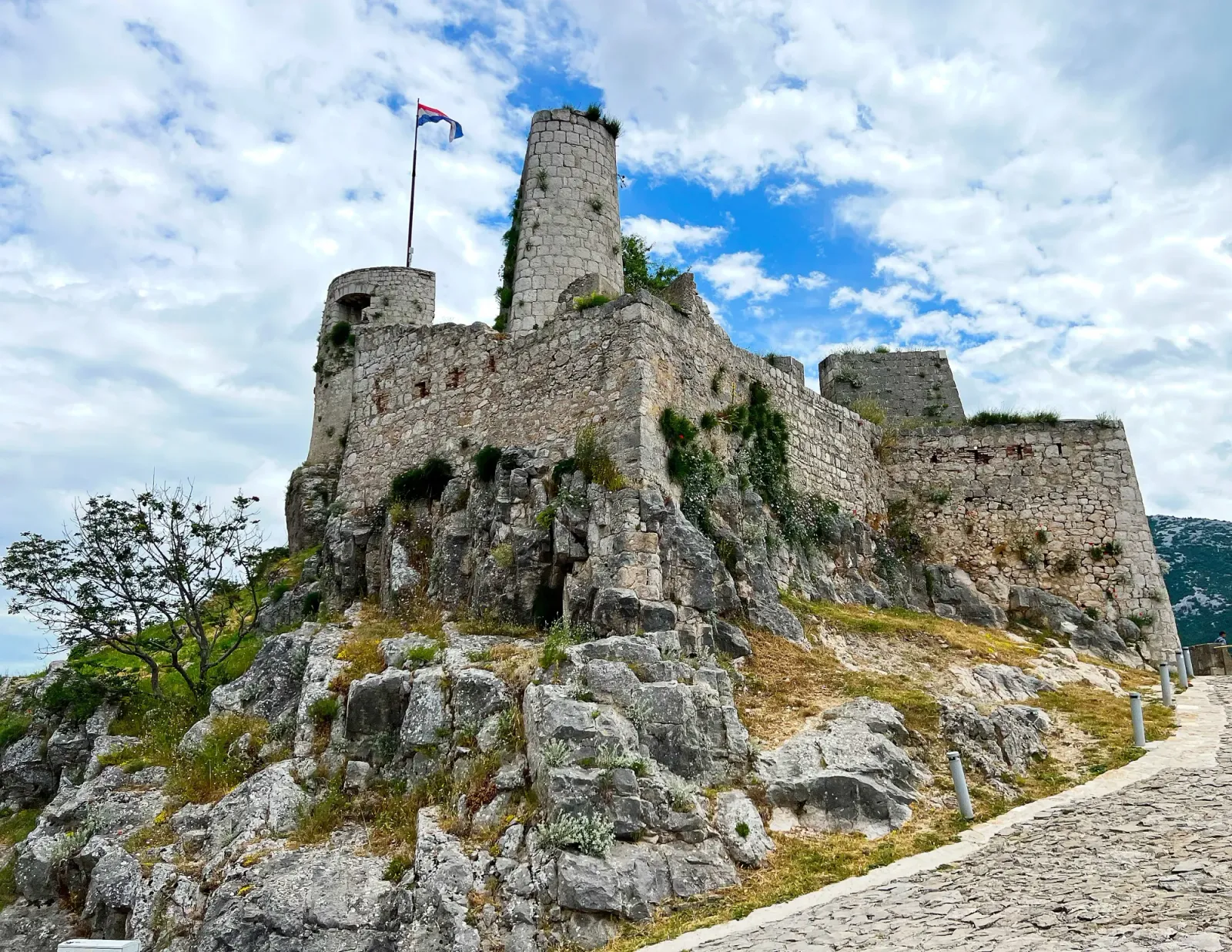 Klis Fortress by Mrs. Wanderer Stone medieval fortress set against a cloudy sky