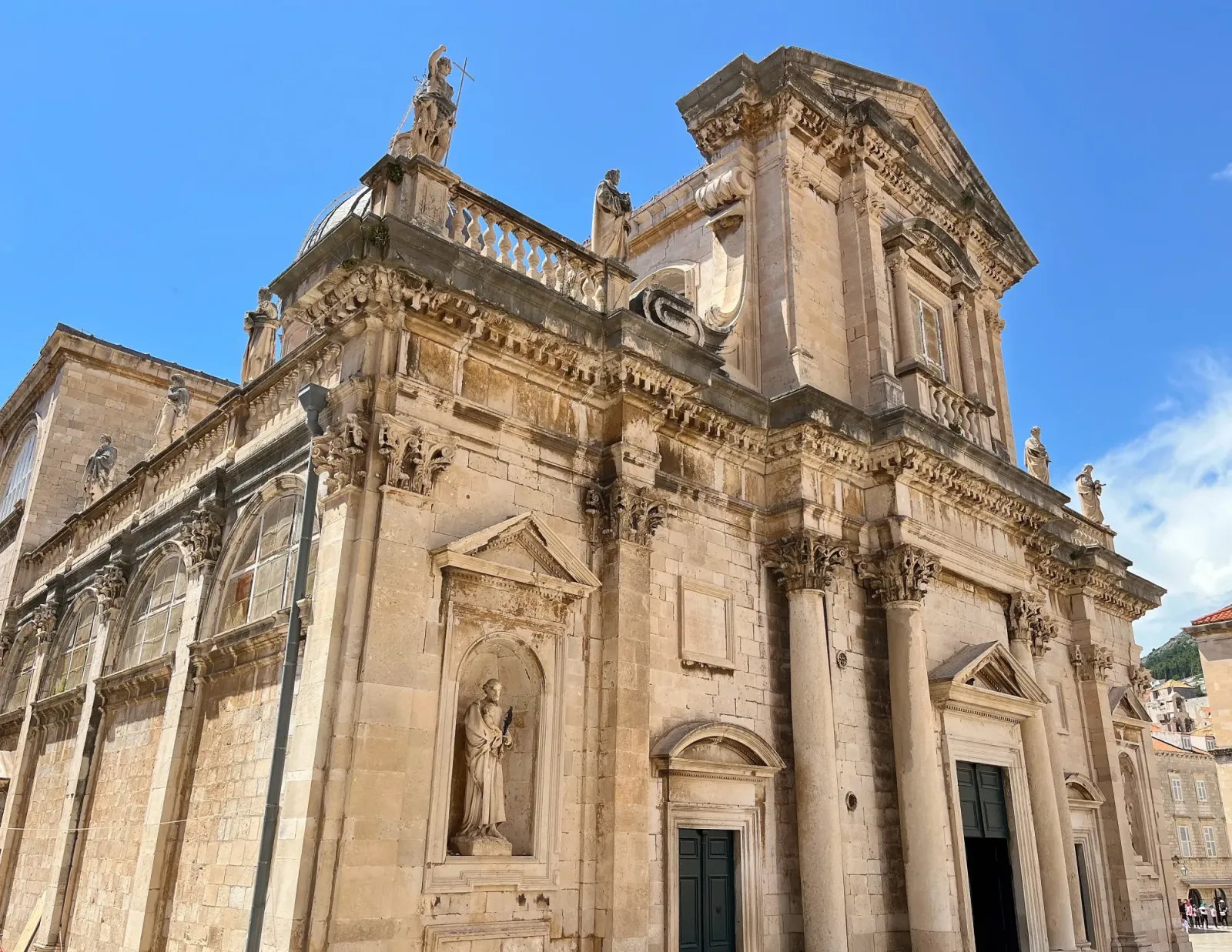 The Cathedral of the Assumption of the Virgin Mary by Mrs. Wanderer Tan stone baroque cathedral with statues of catholic saints