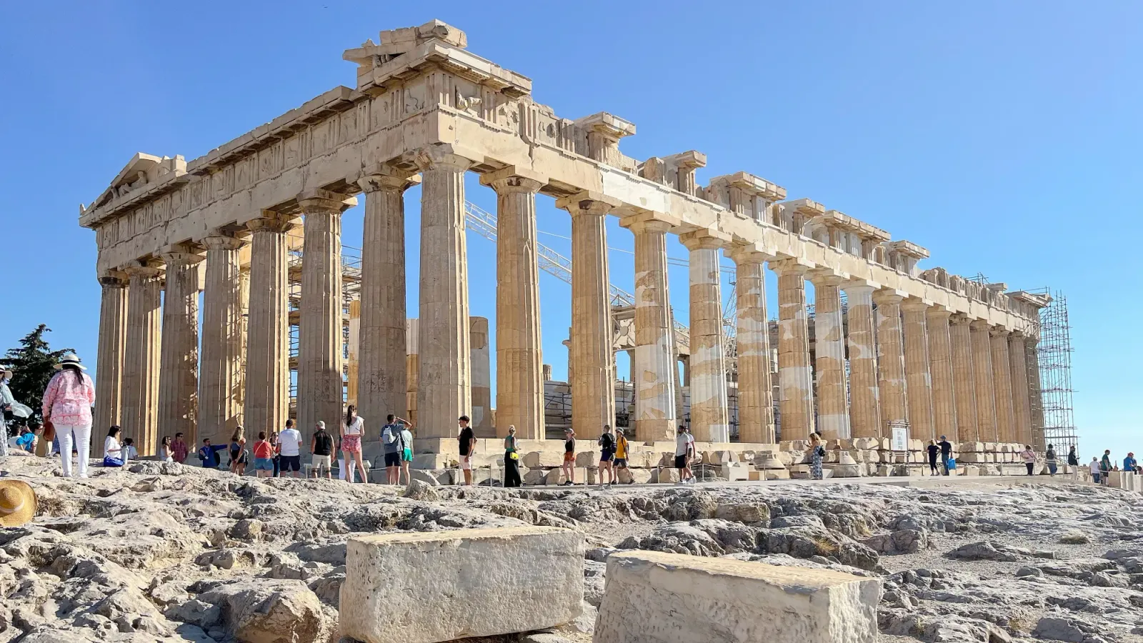 The Parthenon by Mr. Wanderer Columned stone ruins surrounded by tourists