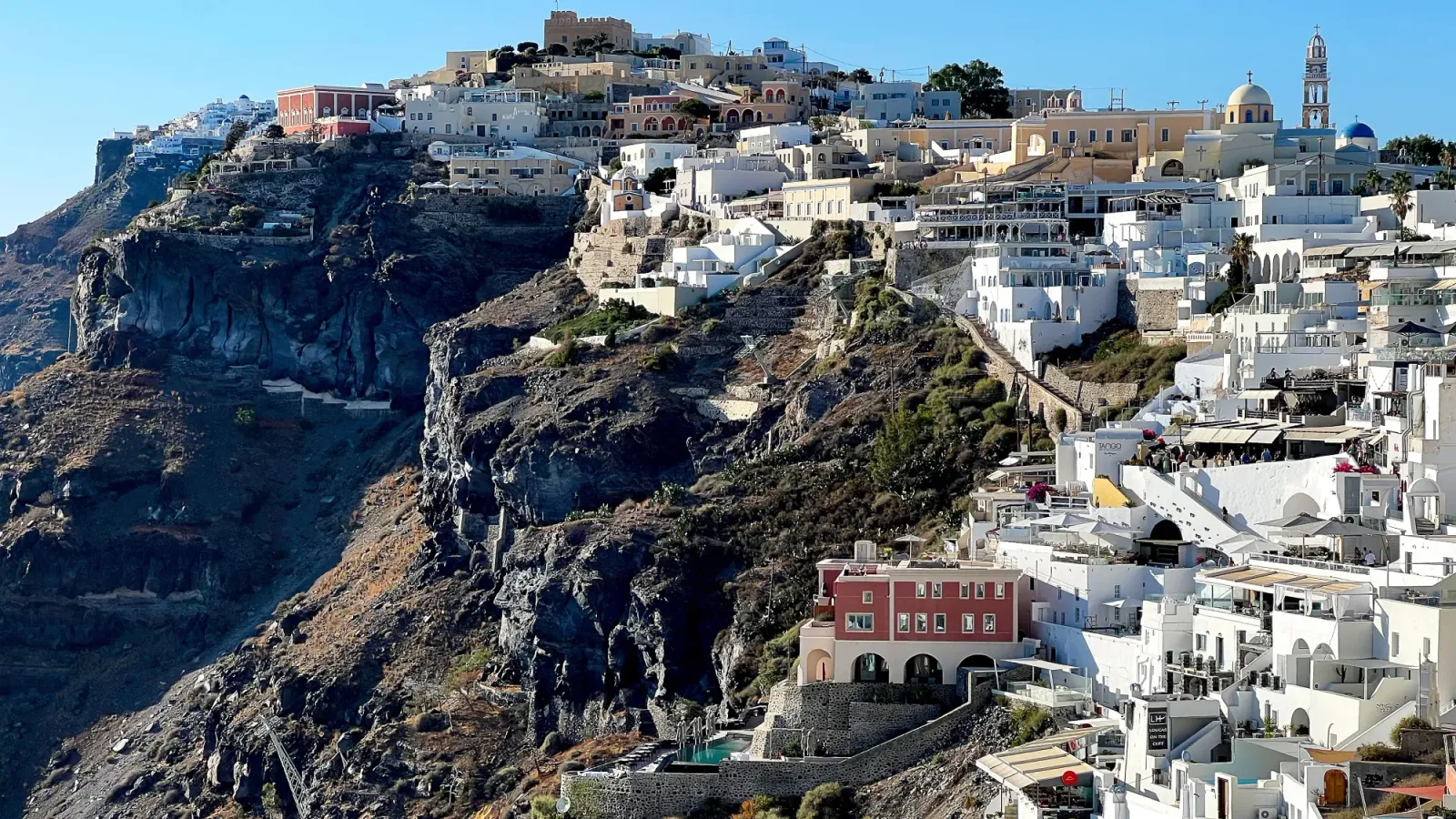 Volcanic Santorini by Mr. Wanderer Black earth with a terraced city of white buildings emerging from it