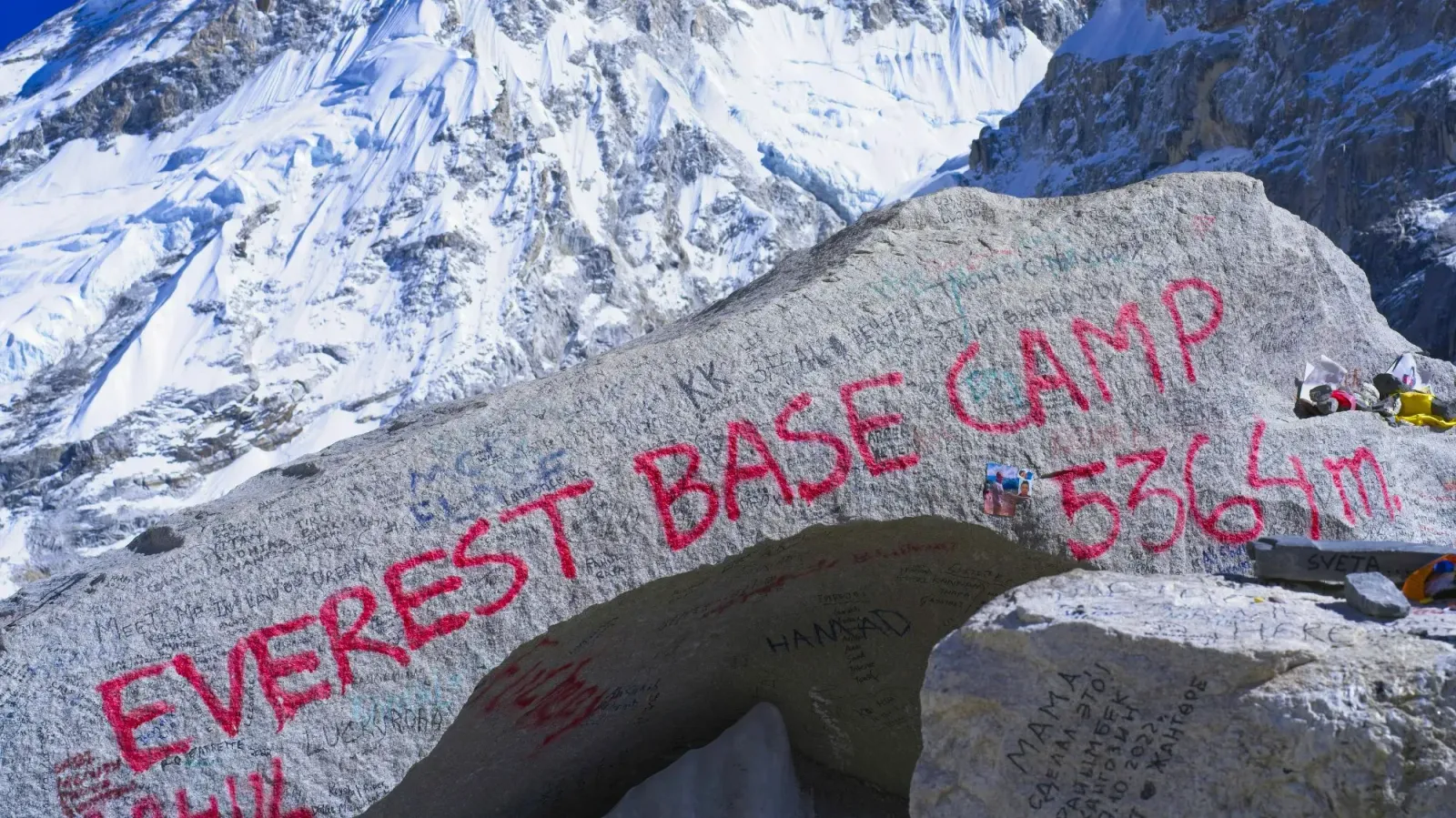 Everest Base Camp Rock by Mr. Wanderer Rock with red spray paint saying "Everest Base Camp 5364m."