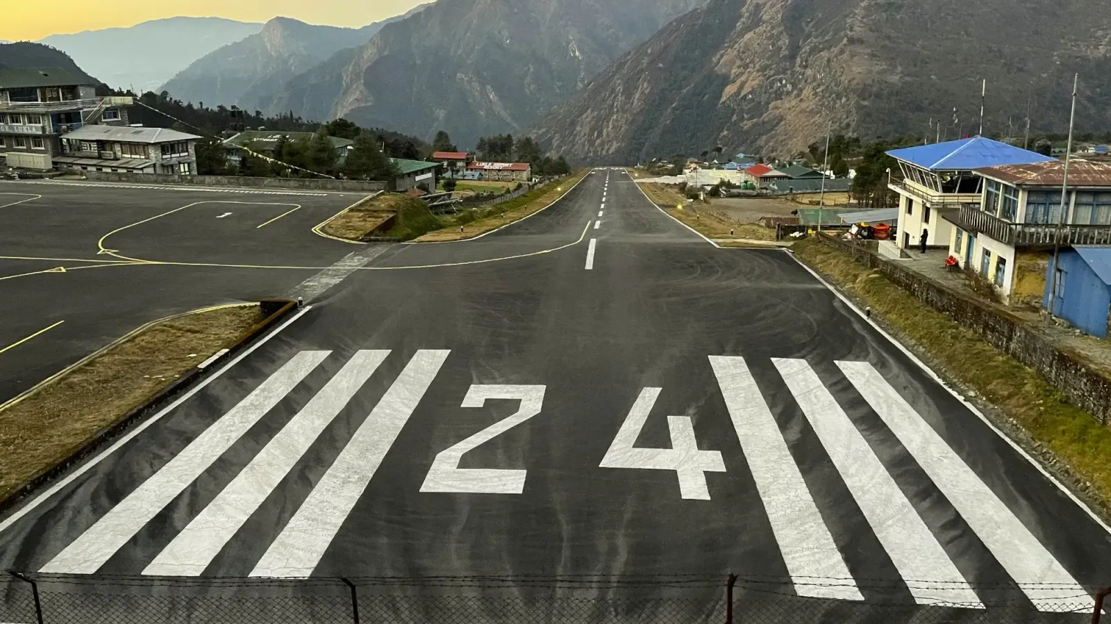 Lukla Airport by Mrs. Wanderer Looking down the Lukla Airport runway off into the valley